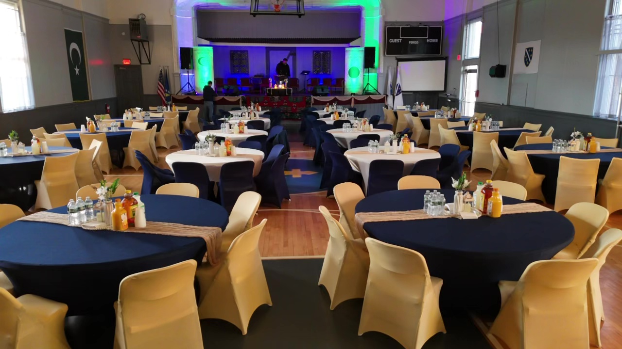 Event hall set up with round tables for a banquet